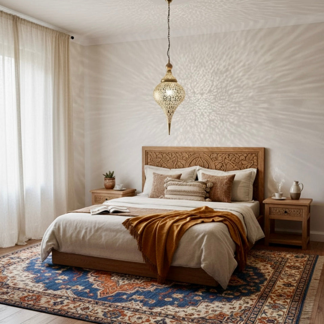 Traditional Moroccan brass filigree pendant light in a minimalist living room setting with grey sofa.
