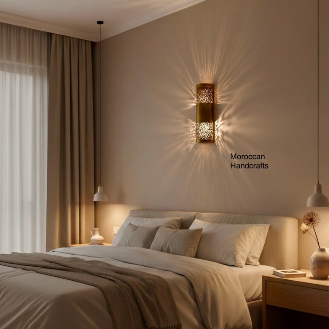 Close-up of a handmade gold-finished Moroccan brass sconce featuring traditional Arabesque patterns and warm ambient lighting.