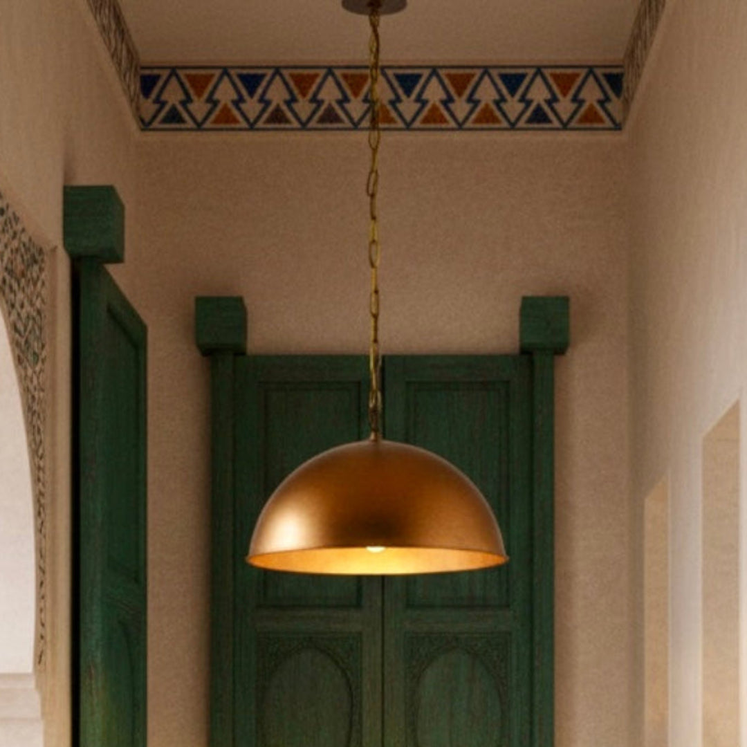 Traditional Moroccan hallway featuring a modern brass-finished dome pendant light with teal carved wooden doors.
