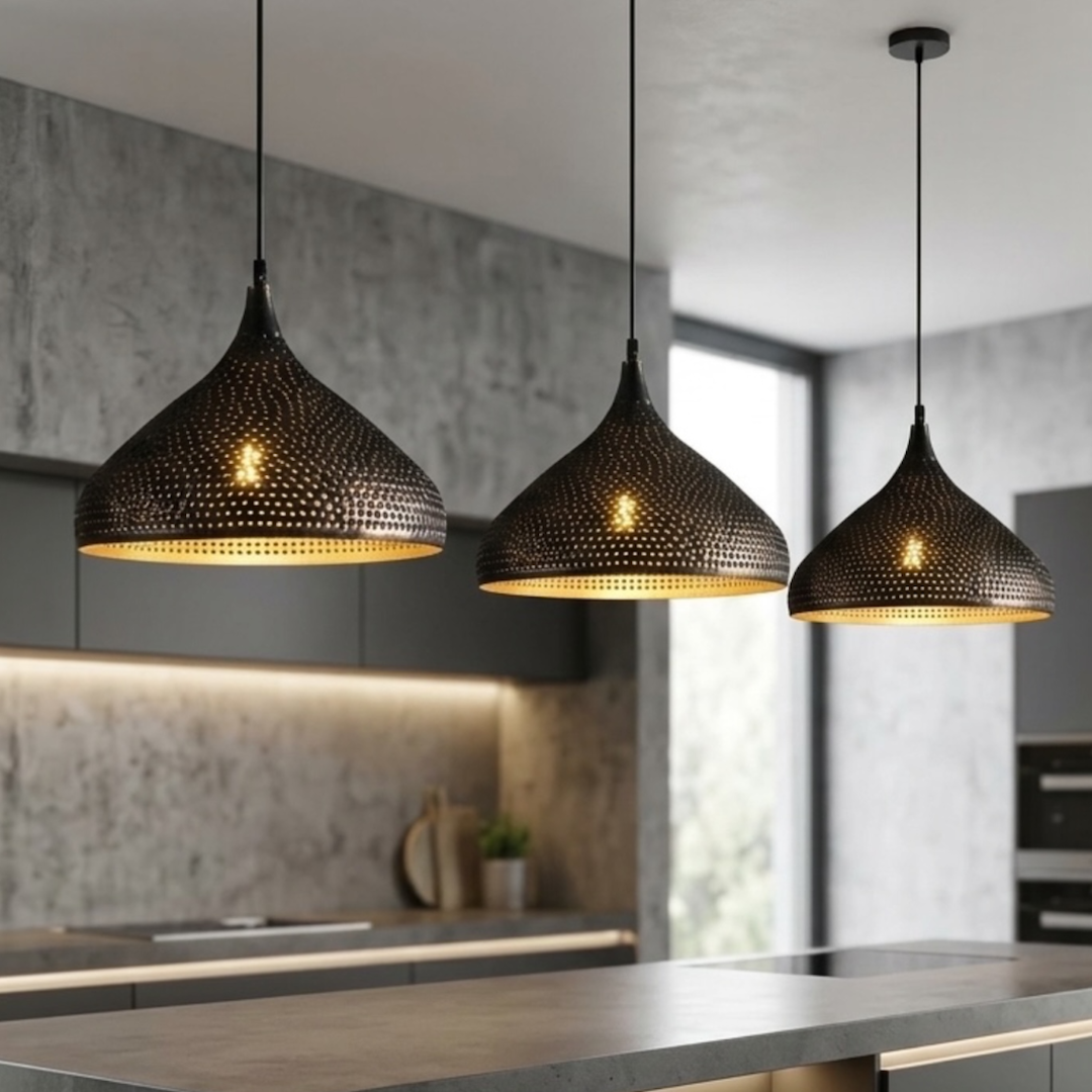 Trio of handmade modern Moroccan dome lights in perforated black brass hanging over a luxury grey kitchen island
