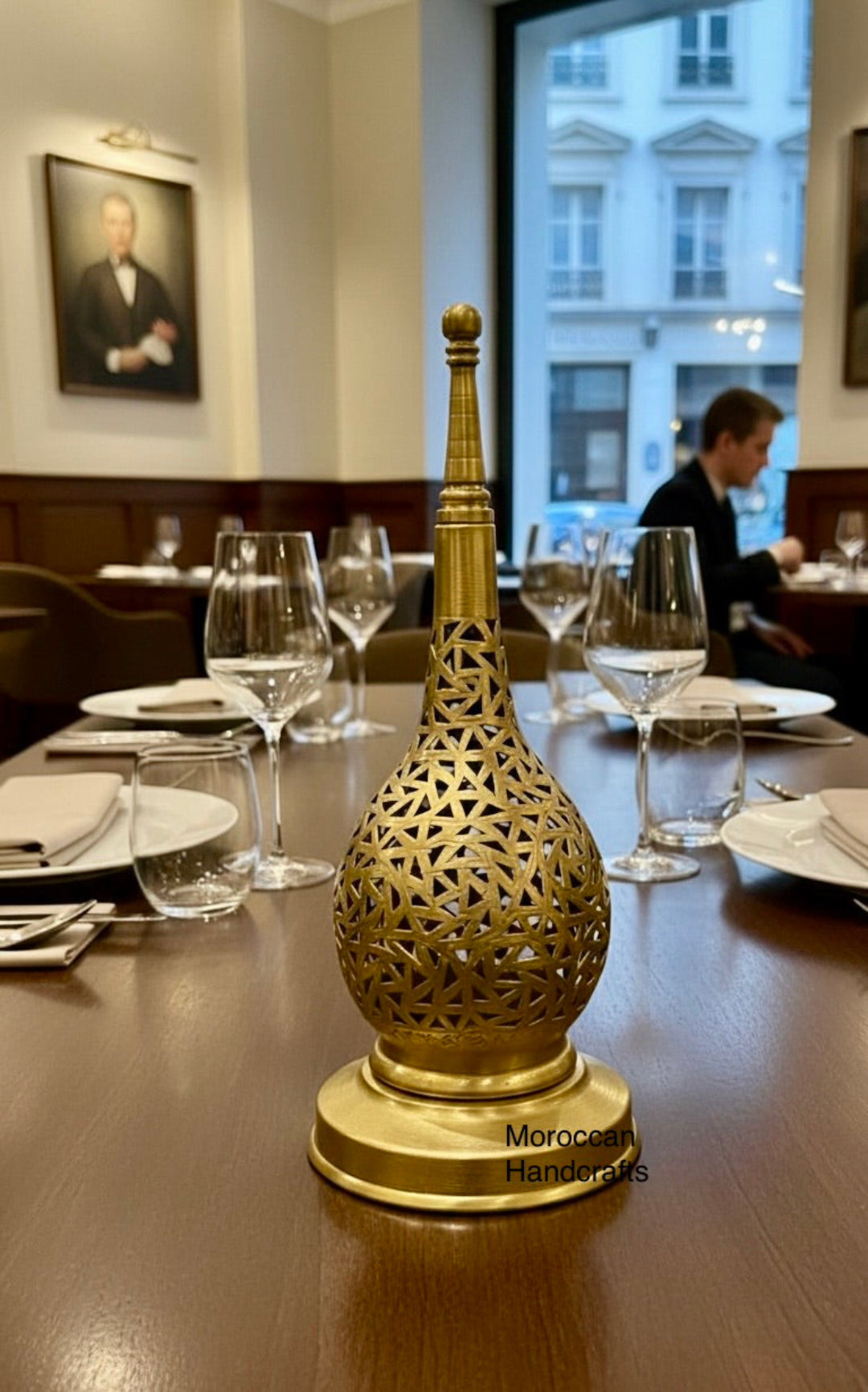 Side view of a teardrop-shaped Moroccan brass lamp with a polished gold finish.