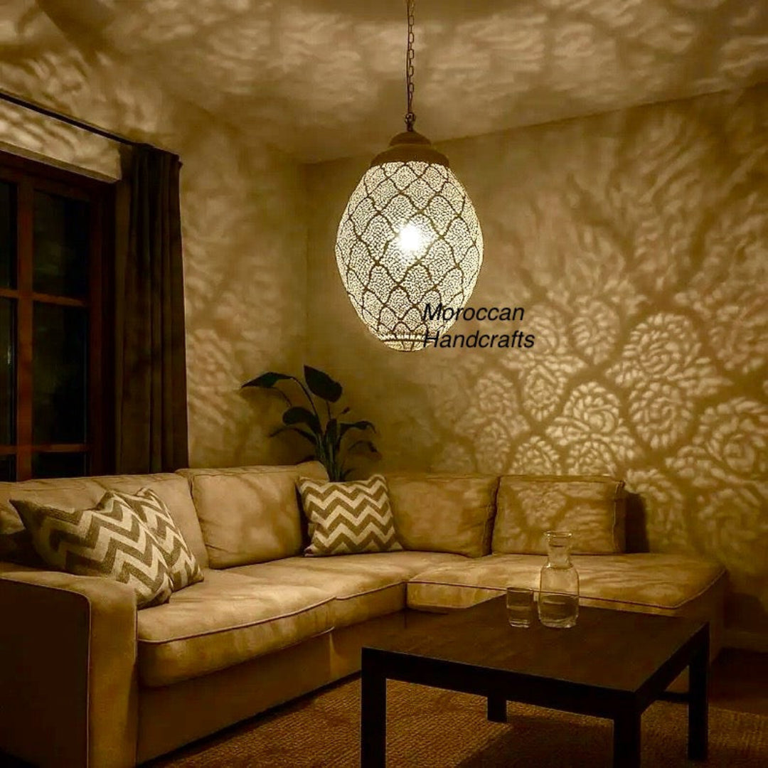 A large, brass pyramid-shaped chandelier with etched patterns, designed as a focal point for a large dining or living room.