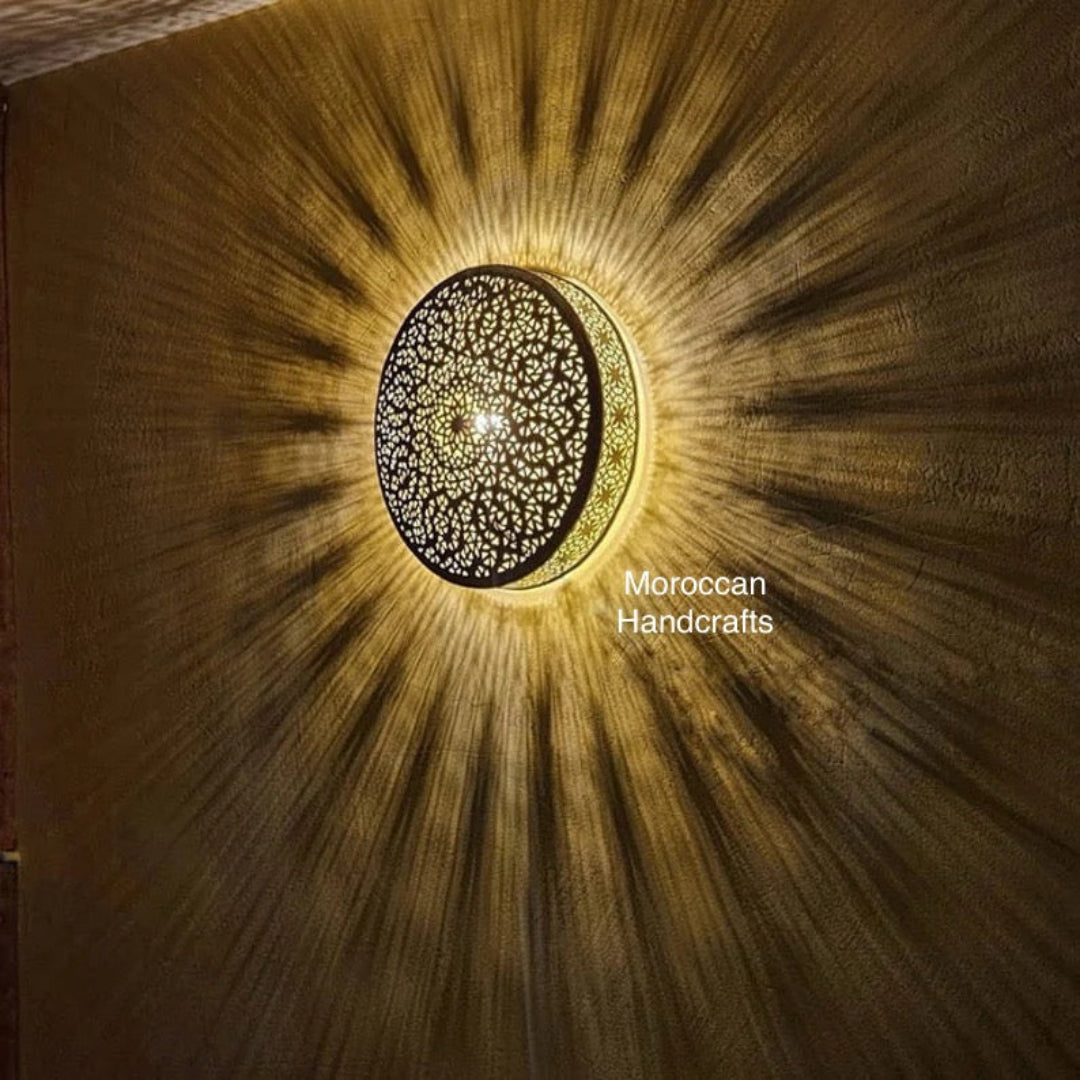 Artisan-made circular brass 'Moon' wall sconce, displaying the craftsmanship of Moroccan handcrafts.