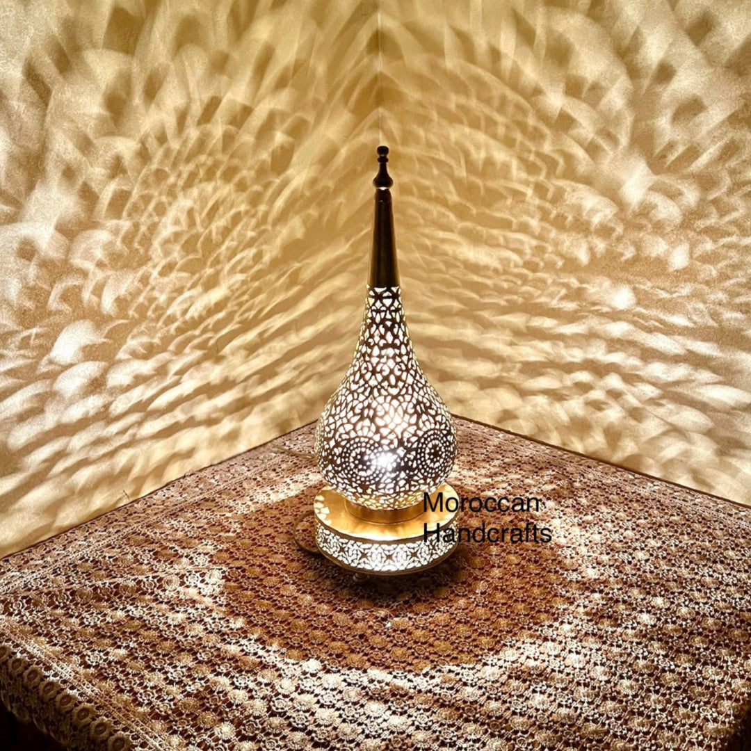 Elegant pierced metal Moroccan lamp for bedside table or living room decor.