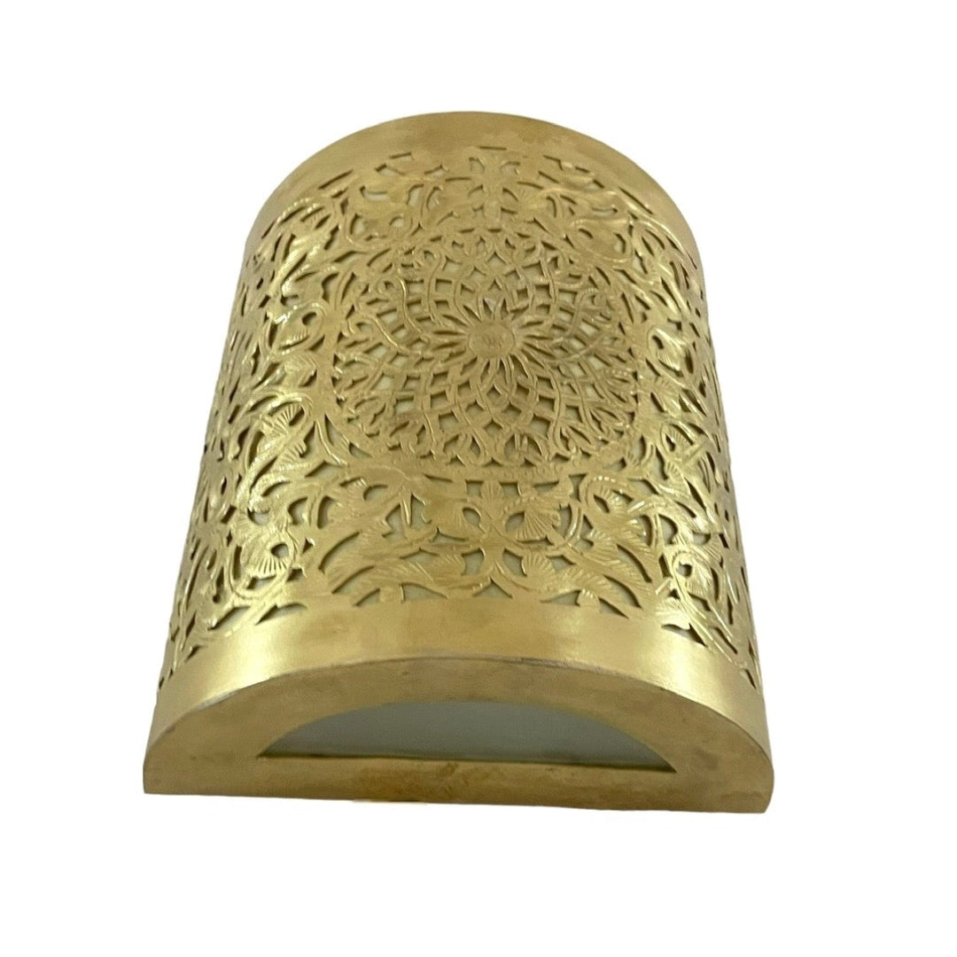 Handmade Moroccan brass sconce with detailed filigree cutout patterns.