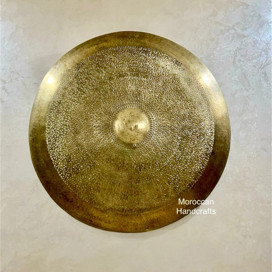 Close-up showing the detailed filigree work and the center opening of the round Moroccan wall light fixture.