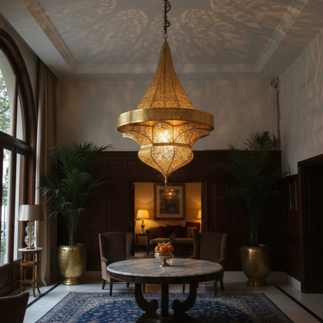 Close-up of a hand-engraved gold brass Moroccan chandelier showing detailed arabesque patterns and traditional craftsmanship for high-end home decor.