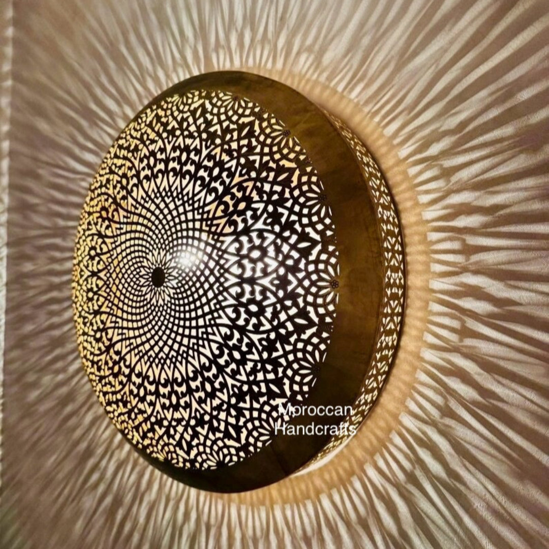 Handmade Moroccan filigree light fixture with a geometric and floral brass cut-out design.