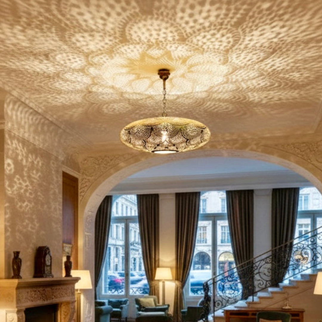 Artisanal brass pendant lamp from Morocco featuring hand-punched lace-like designs.