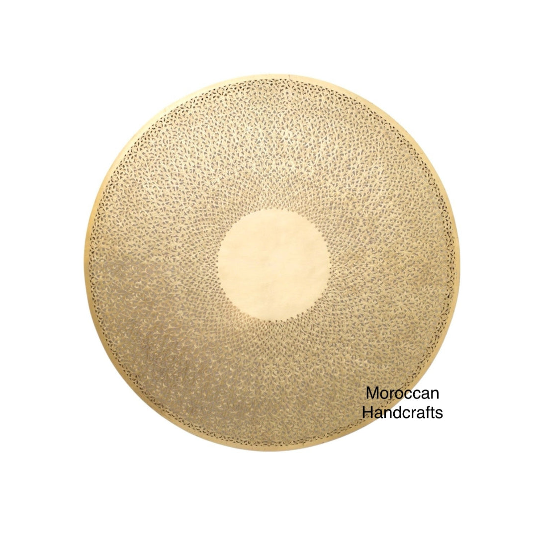 Close-up of the delicate, hand-pierced floral pattern on the round Moroccan light fixture.
