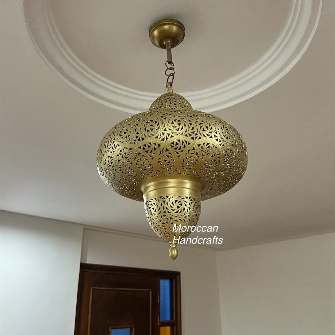 A six-pointed star-shaped Moroccan ceiling lantern crafted from perforated brass, designed to cast delicate, star-shaped light patterns across a ceiling or wall.