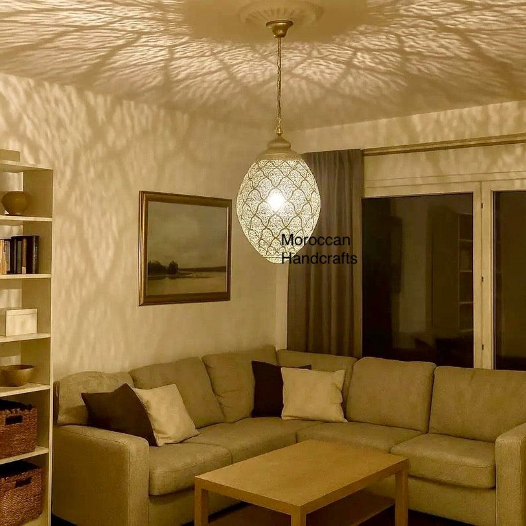 A tall, teardrop-shaped pendant lamp crafted from hammered copper, featuring a dark, rustic finish suitable for a hallway or entryway.