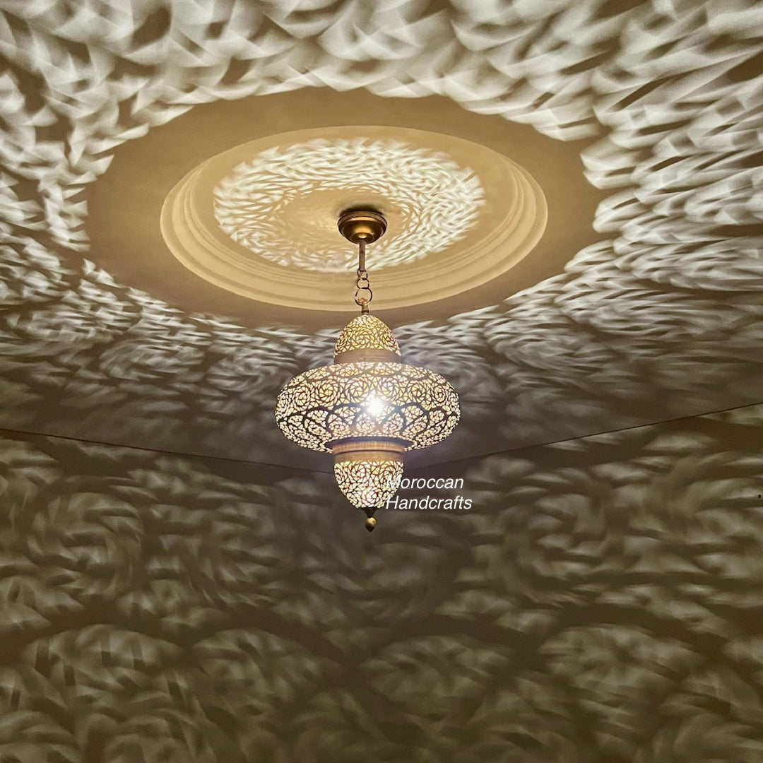 A six-pointed star-shaped Moroccan ceiling lantern crafted from perforated brass, designed to cast delicate, star-shaped light patterns across a ceiling or wall.
