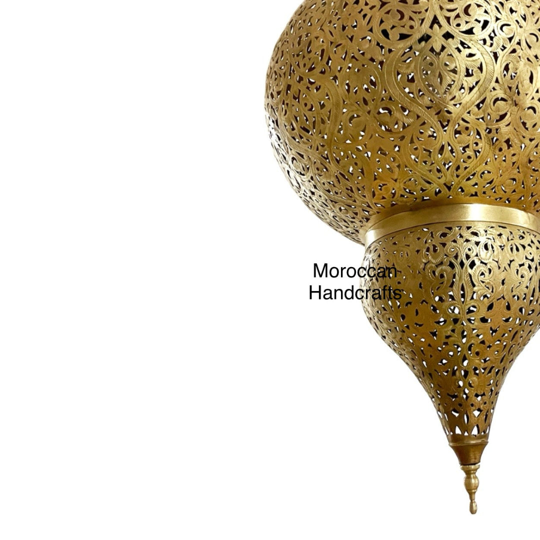 Oriental/Moorish style hanging lamp with detailed geometric perforations illuminating a room with soft, patterned light.