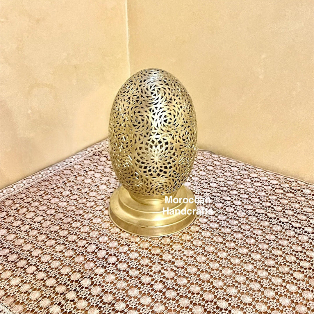 Moroccan [Material] lantern featuring colored [Color] glass panels and an intricate [Detail] motif, hanging in a [Setting].