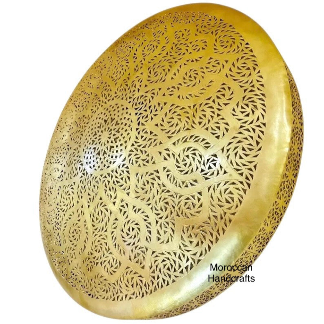 Traditional Moroccan light fixture, a punched brass sconce suitable for living room or hallway decor.