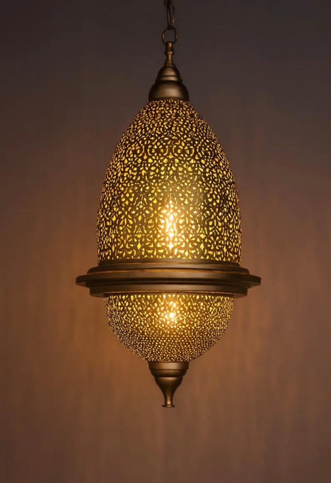  Handcrafted Moroccan brass teardrop pendant light with a polished finish and intricate perforation.