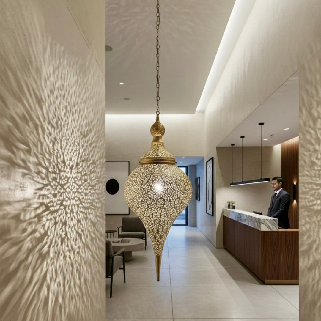 Bohemian style Moroccan brass ceiling light installed in a bedroom above a carved wooden headboard