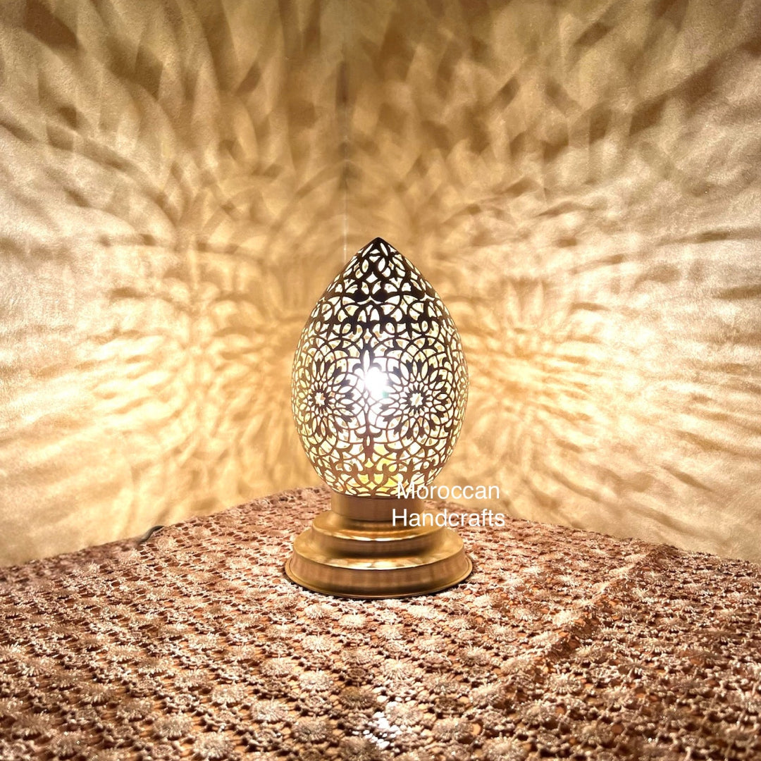 Elegant almond-shaped metal lantern, perfect for warm, low lighting in a bohemian bedroom decor setting.