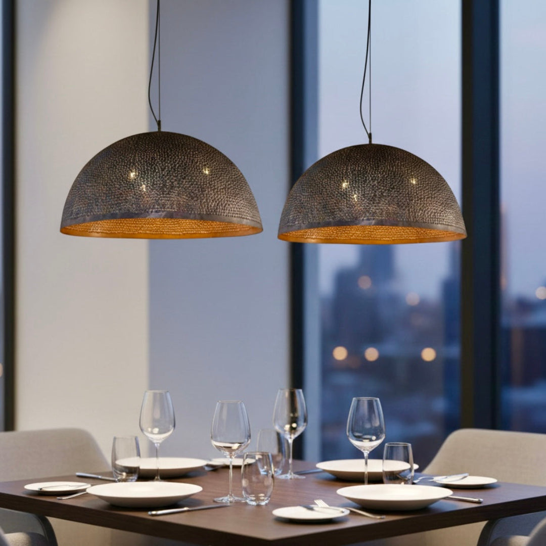 Close-up of a handmade Moroccan dome lamp showing the detailed hammered brass texture and gold interior finish.