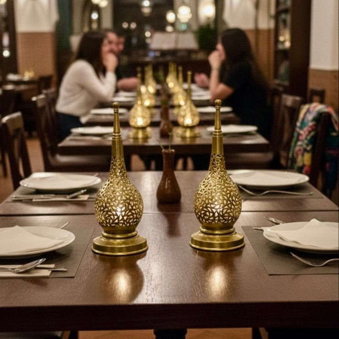 Warm ambient lighting from a Moroccan brass fanoos in a luxury restaurant setting.