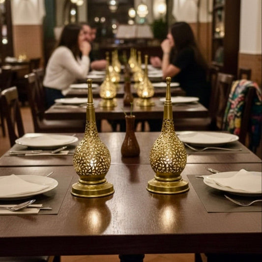 Warm ambient lighting from a Moroccan brass fanoos in a luxury restaurant setting.