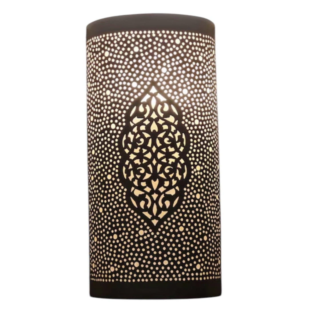  Authentic Moroccan brass wall sconce glowing with warm light, showcasing traditional artisanal craftsmanship.