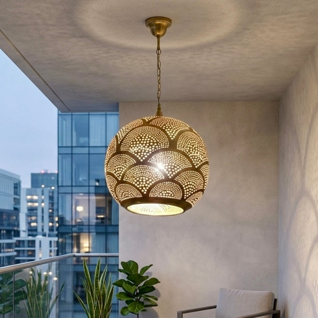 Full view of an authentic gold-toned Moroccan brass globe light fixture, showcasing the artisan craftsmanship and the unique shadow patterns it projects.
