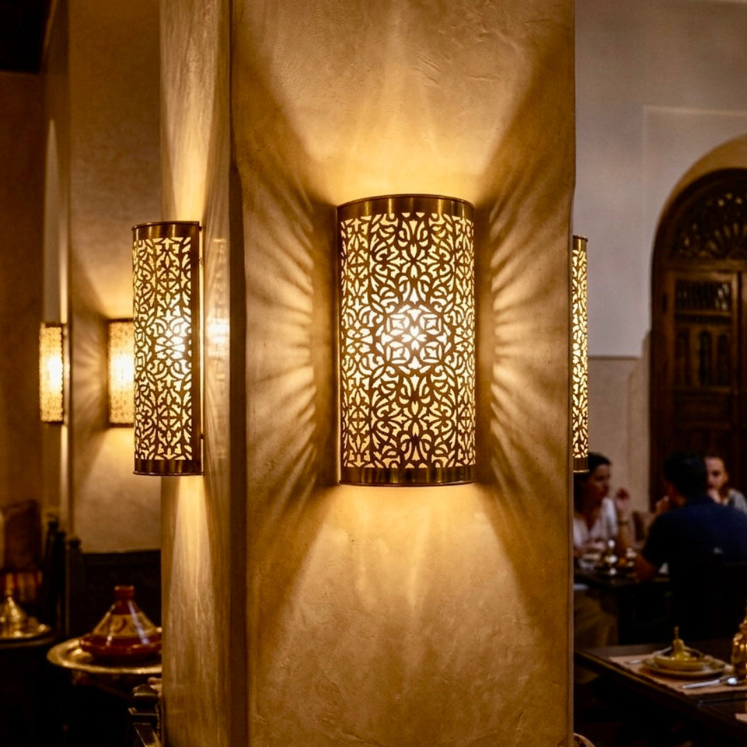 Stylish brass wall sconces in a sophisticated dining area, perfect for modern and Moroccan interior design.