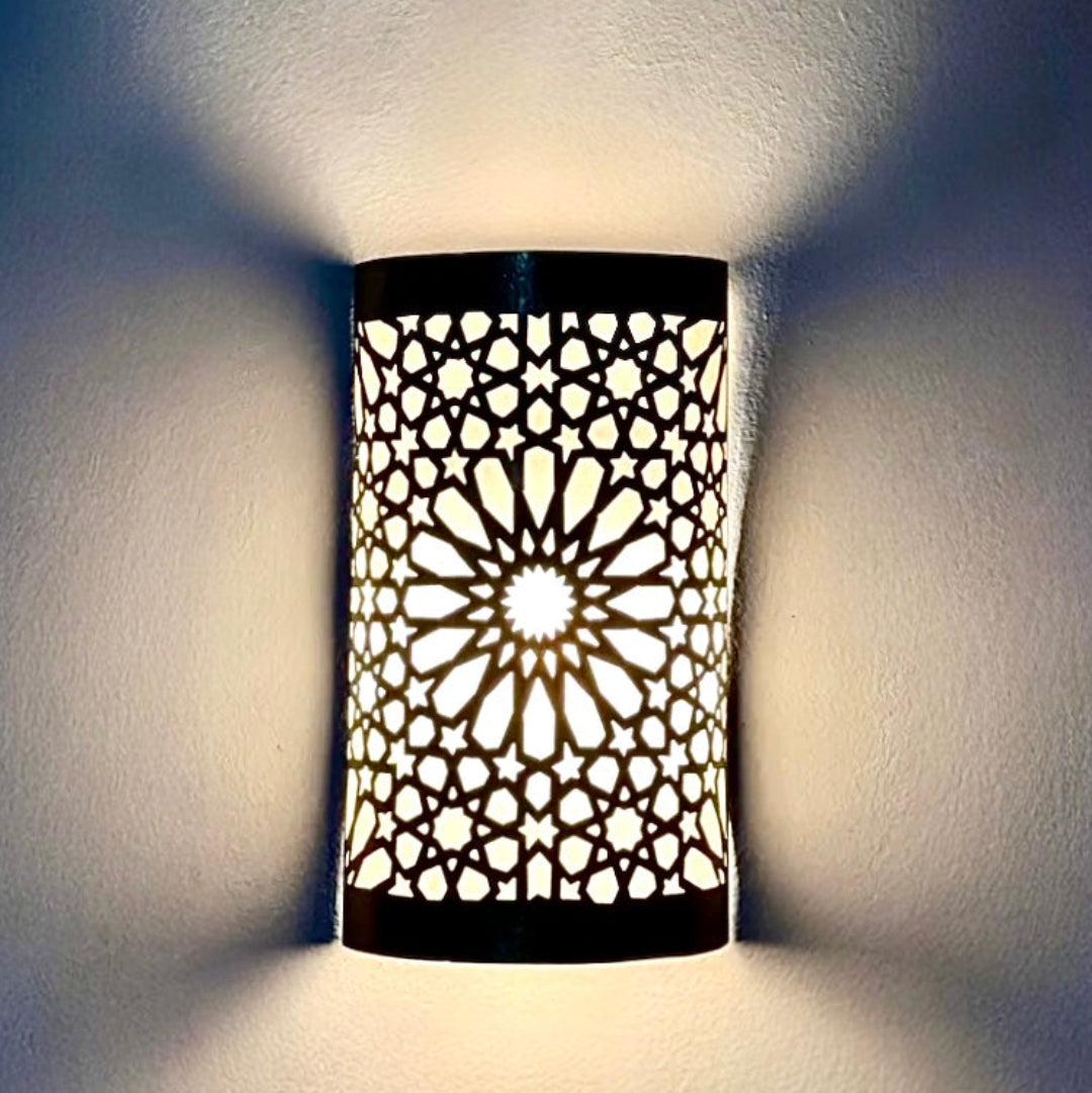 Contemporary living room interior with a large Moroccan brass wall sconce as a statement piece, blending modern furniture with ethnic lighting.