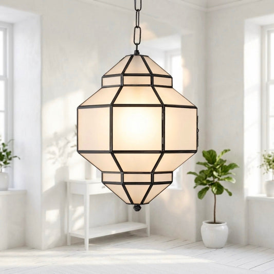 Close-up of an illuminated handmade Moroccan brass chandelier with frosted glass panels in a modern bright room.⁠