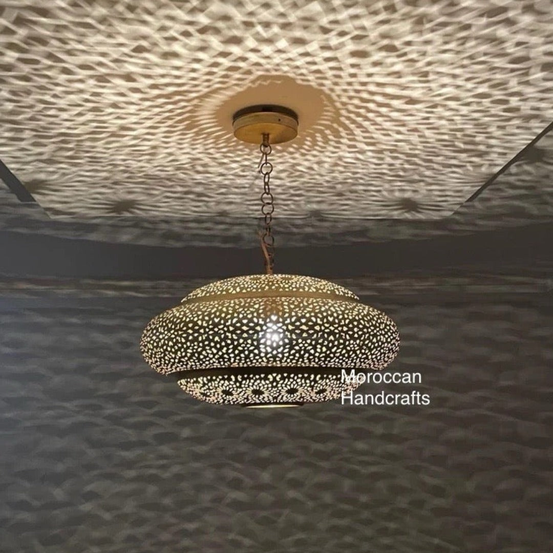 Close-up of hand-punched floral motifs on a traditional Moroccan brass lamp.
