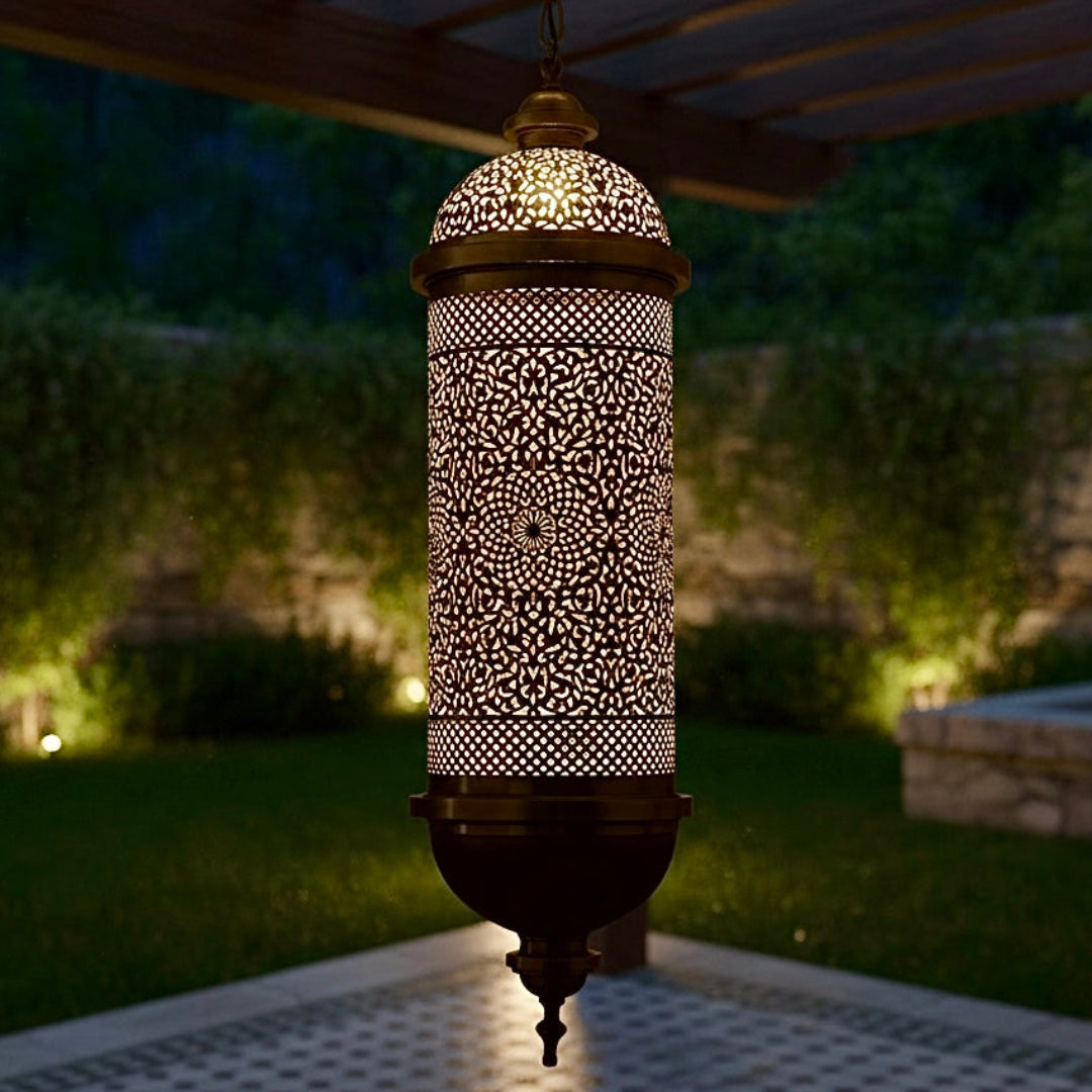 Elegant handcrafted brass Moroccan lantern hanging outdoors on a pergola, providing warm ambient lighting for a garden space.