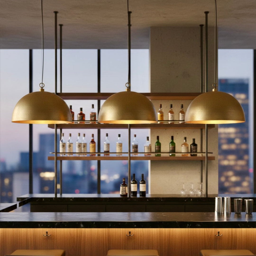 High-quality product shot of a handcrafted Moroccan hammered brass dome lamp with a warm gold interior on a white background.