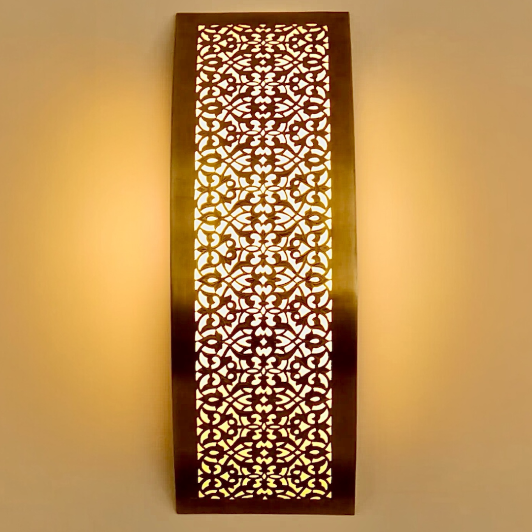 Frontal view of a handmade brass Moroccan wall lamp featuring traditional geometric perforated patterns.