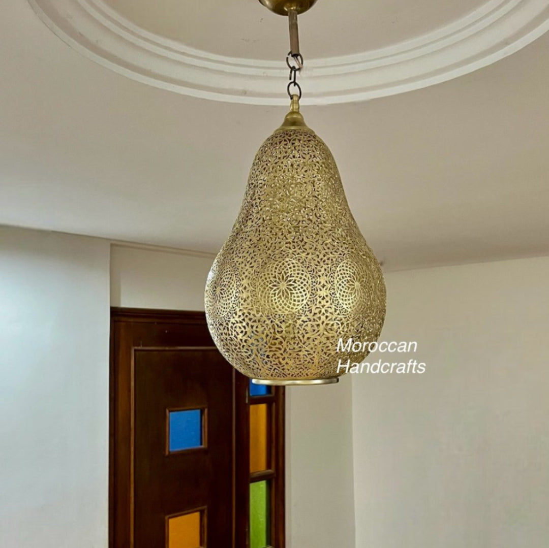  Detailed view of a handmade Moroccan filigree brass lamp showing the intricate perforated patterns and golden finish.