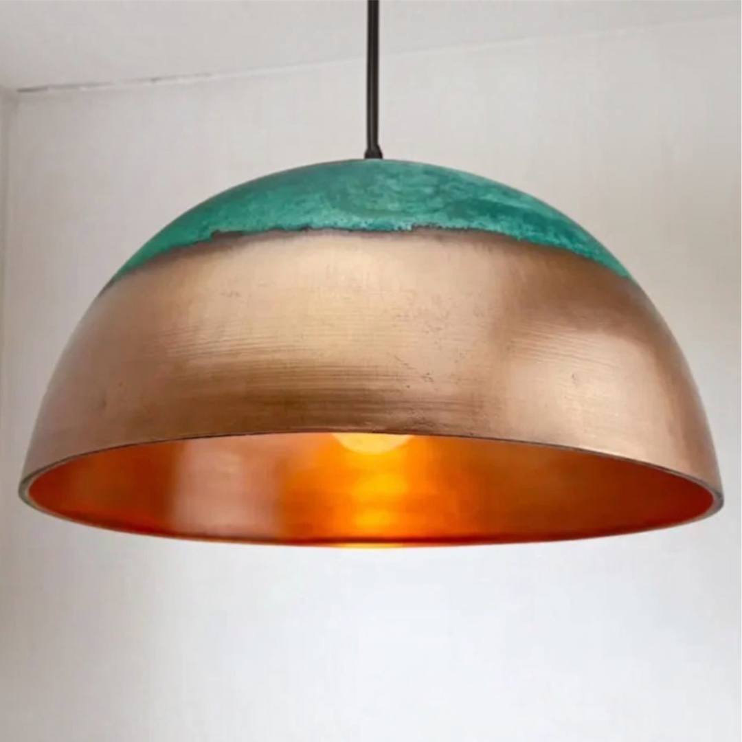  Detailed close-up of a handcrafted Moroccan brass dome light showing the polished copper interior and warm bulb illumination