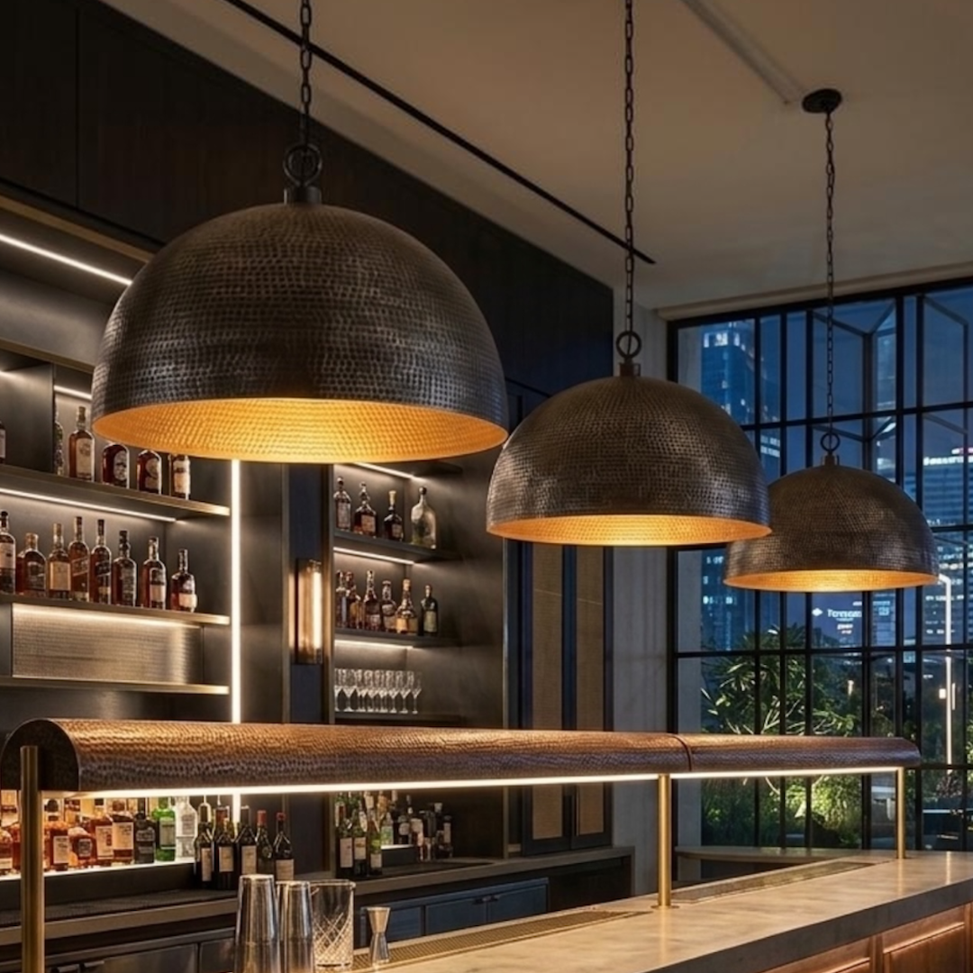 Modern Moroccan handmade brass dome pendant lamps hanging over an elegant commercial bar counter with ambient evening lighting