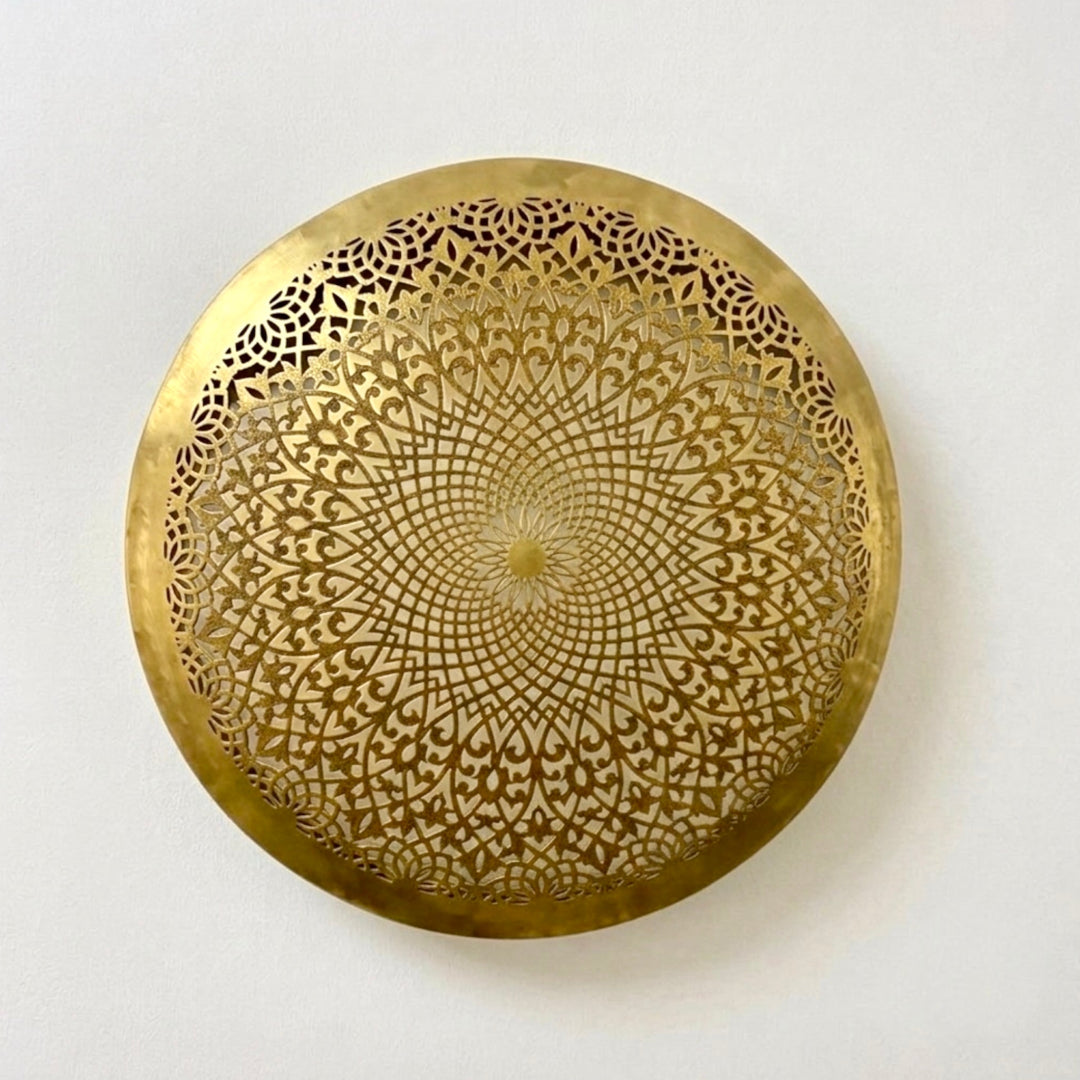 Close-up of a round unlit handmade Moroccan ceiling lamp made of authentic gold brass, featuring a highly detailed geometric arabesque cutout design against a white background.