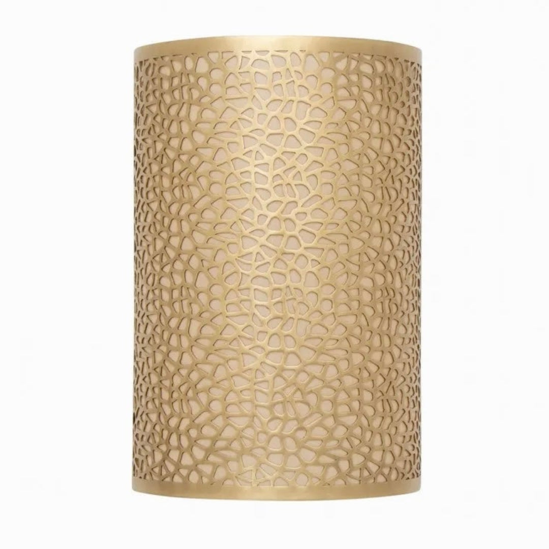Handcrafted Moroccan brass wall lamp with intricate perforated pattern, cylindrical gold sconce for modern luxury interior lighting.