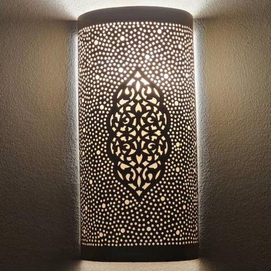 Front view of a handcrafted Moroccan brass wall sconce with intricate geometric perforations on a white background.