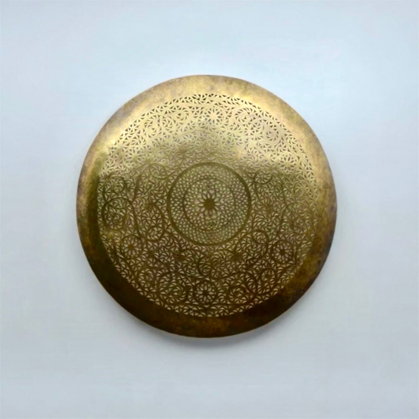 Front view of a round handmade Moroccan ceiling light in unlit antique brass finish against a clean white background.