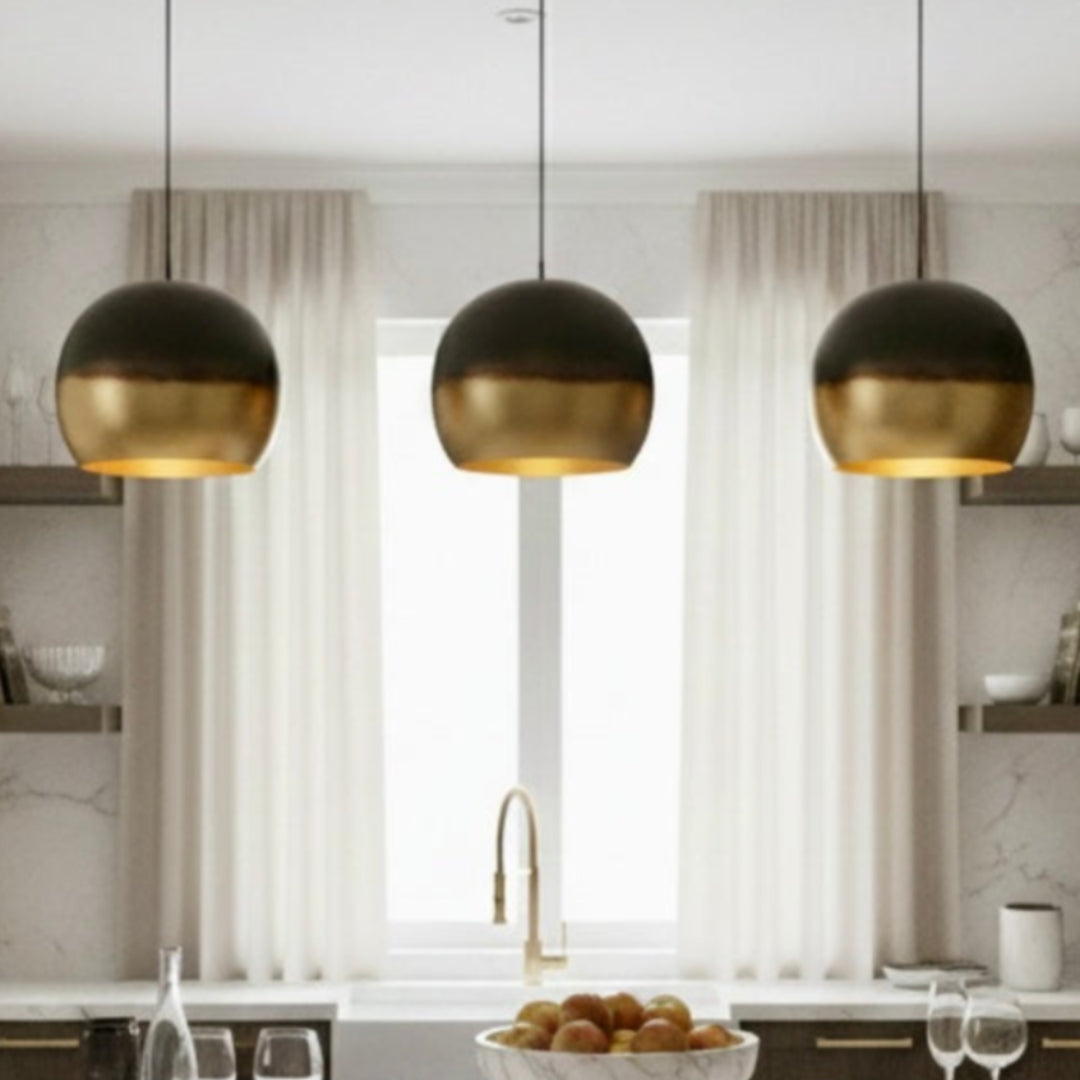 Close-up studio shot of a handmade Moroccan dome lamp showing the transition from dark burnt copper to polished brass finish.