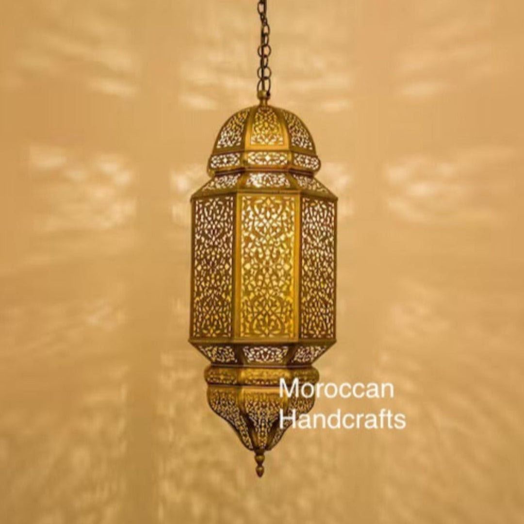  Large handmade Moroccan brass pendant lamp in a modern minimalist restaurant setting, casting intricate light patterns.