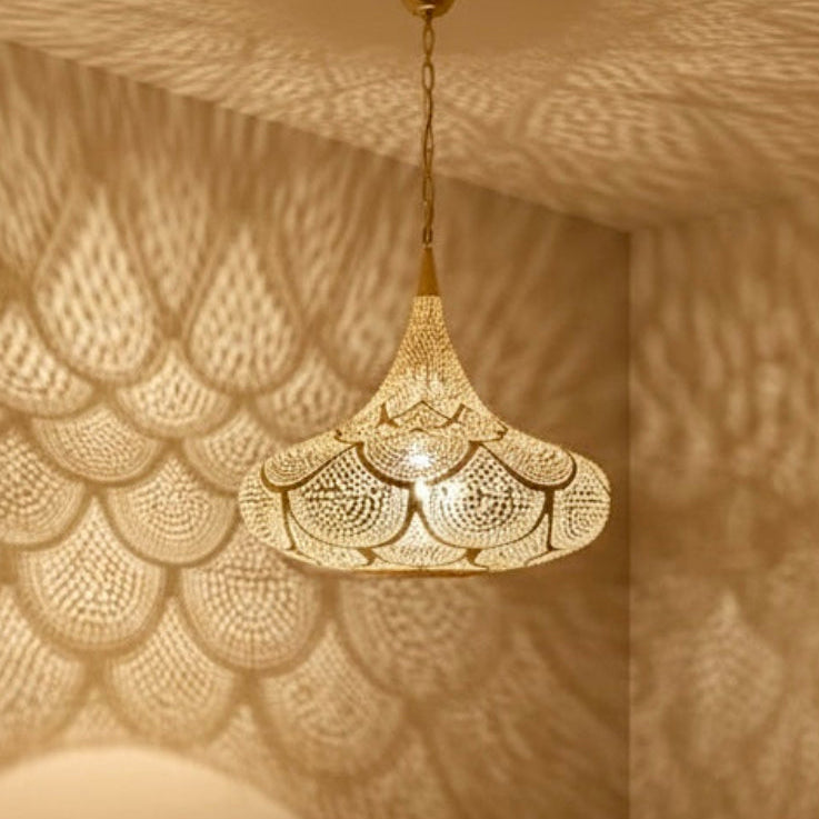  Stunning Moroccan brass pendant lamp and matching wall sconces in a modern green velvet living room.