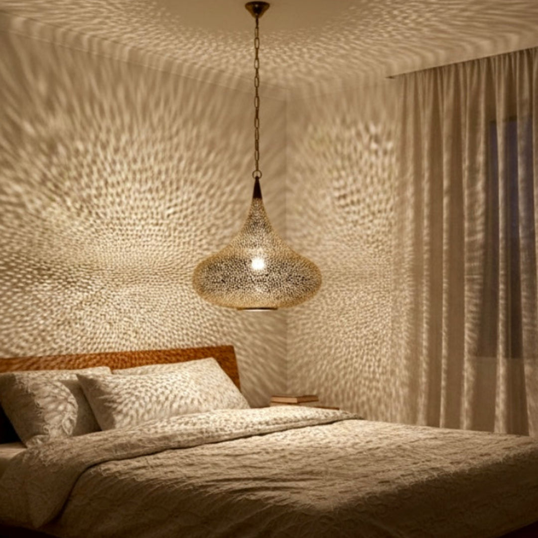 Large teardrop-shaped Moroccan brass chandelier in a luxury interior with classical paintings and elegant molding.