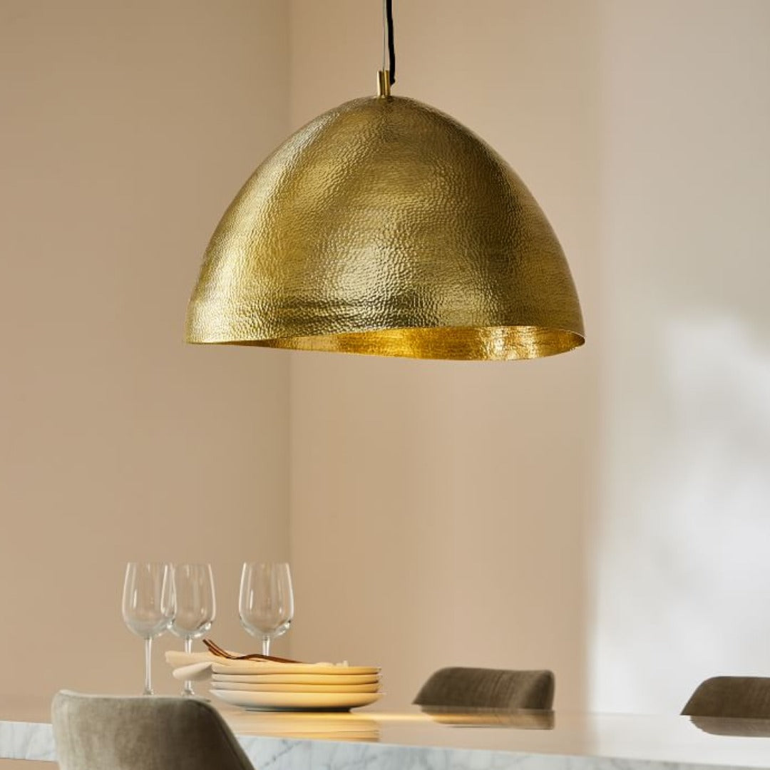 Elegant handmade brass dome lamp providing warm ambient lighting in a high-end interior space.