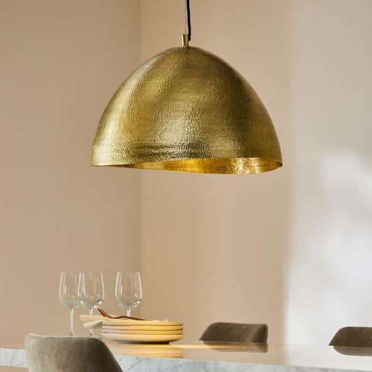 Elegant handmade brass dome lamp providing warm ambient lighting in a high-end interior space.