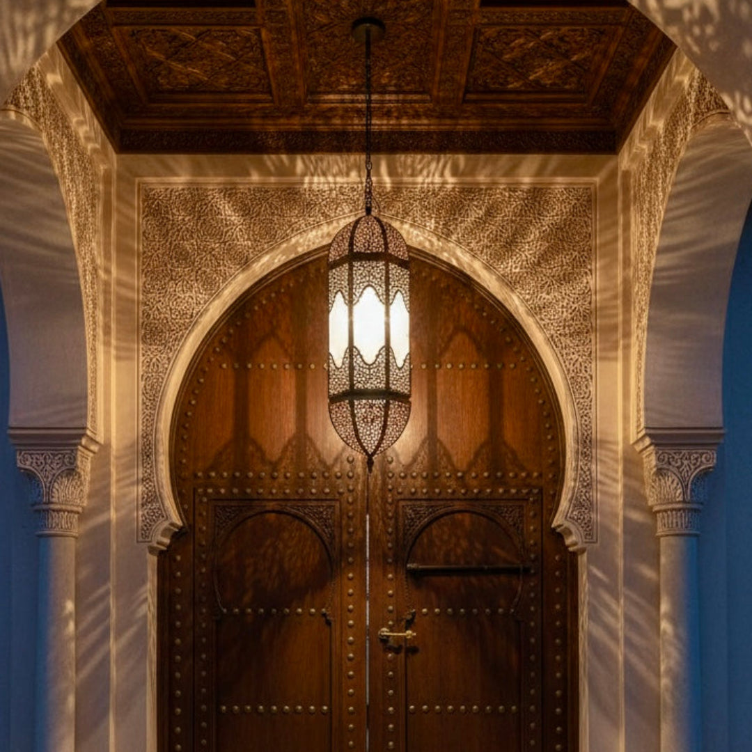 Luxurious Moroccan pendant light fixture hanging in an elegant arched doorway entrance.