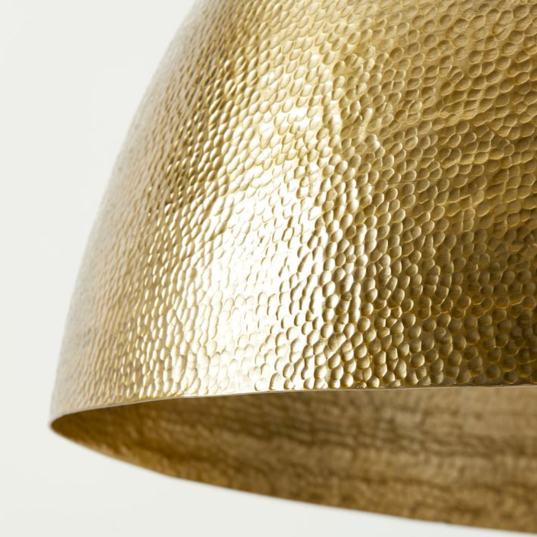  Modern Moroccan inspired brass dome light fixture adding warmth to a contemporary living room interior.